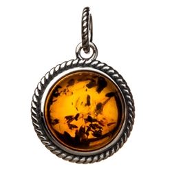 Sterling Silver framing a beautiful honey amber cabochon center.
