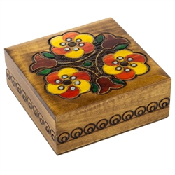 This wooden box is decorated with three bright, colorful flowers and three tulips. A circular design borders the sides of the box.