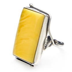 A beautiful slice of custard amber framed in a classic sterling silver frame with leaf detail. Size is approx 1.25" x .75". Only one piece this size is available.
