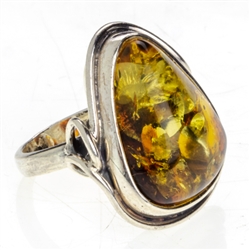 A nicely cut triangular amber cabochon set in sterling silver. Amber size is approx .5" x .75"