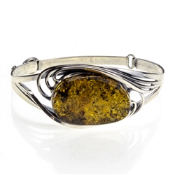 This sterling silver bracelet features a gorgeous oval amber cabochon. Size is 6.75" diameter.  Cabochon size is approx 1" x 1.25".