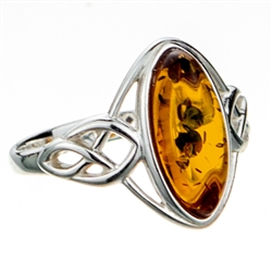 Silver band with a Celtic design showcasing a honey amber cabochon.  Cabochon size is approx .6" x .4".