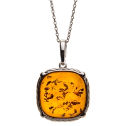 Sterling silver frame for a beautiful honey amber cabochon. Pendant size is approx. .8" x .8".