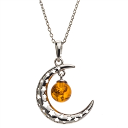 Sterling silver moon suspending beautiful honey amber cabochon drop. Pendant size is approx. 1.2" x .8".
