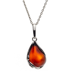 A beautiful cherry amber cabochon framed in an open back sterling silver frame. Pendant size is approx. 1" x .5".