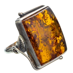 A beautiful amber cabochon framed in a classic sterling silver frame. Size is approx 1.1" x 1".