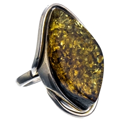 A beautiful amber cabochon framed in a classic sterling silver frame. Size is approx 1.25" x .75".