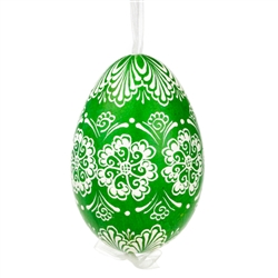 This beautifully designed egg is dyed one color, then white wax is melted and applied to form an intricate design which is left on the surfce. The egg is emptied and strung with ribbon for hanging.