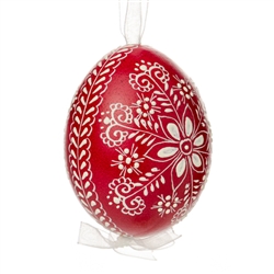 This beautifully designed egg is dyed one color, then white wax is melted and applied to form an intricate design which is left on the surfce. The egg is emptied and strung with ribbon for hanging.