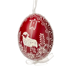 This beautifully designed egg is dyed one color, then white wax is melted and applied to form an intricate design which is left on the surfce. The egg is emptied and strung with ribbon for hanging.