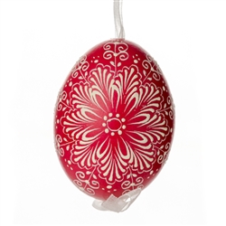 This beautifully designed egg is dyed one color, then white wax is melted and applied to form an intricate design which is left on the surfce. The egg is emptied and strung with ribbon for hanging.