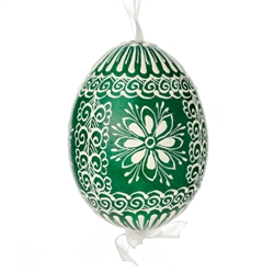 This beautifully designed egg is dyed one color, then white wax is melted and applied to form an intricate design which is left on the surfce. The egg is emptied and strung with ribbon for hanging.