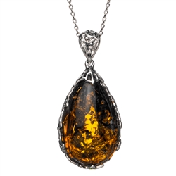 Beautiful sterling silver pendant and adjustable length chain.  Sterling silver filigree like frame around this beautiful piece of amber.