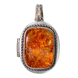 Beautiful honey amber pendant set in sterling silver opens to reveal a locket. Size is approx 1.75' x 1" (closed).