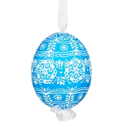 This beautifully designed egg is dyed one color, then white wax is melted and applied to form an intricate design which is left on the surfce. The egg is emptied and strung with ribbon for hanging.