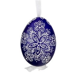 This beautifully designed egg is dyed one color, then white wax is melted and applied to form an intricate design which is left on the surfce. The egg is emptied and strung with ribbon for hanging.