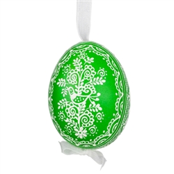 This beautifully designed egg is dyed one color, then white wax is melted and applied to form an intricate design which is left on the surfce. The egg is emptied and strung with ribbon for hanging.