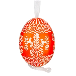 This beautifully designed egg is dyed one color, then white wax is melted and applied to form an intricate design which is left on the surfce. The egg is emptied and strung with ribbon for hanging.