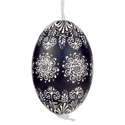 This beautifully designed egg is dyed one color, then white wax is melted and applied to form an intricate design which is left on the surfce. The egg is emptied and strung with ribbon for hanging.