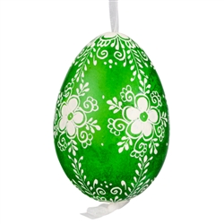 This beautifully designed egg is dyed one color, then white wax is melted and applied to form an intricate design which is left on the surfce. The egg is emptied and strung with ribbon for hanging.