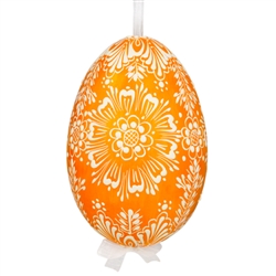 This beautifully designed egg is dyed one color, then white wax is melted and applied to form an intricate design which is left on the surfce. The egg is emptied and strung with ribbon for hanging.