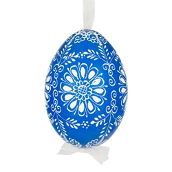 This beautifully designed egg is dyed one color, then white wax is melted and applied to form an intricate design which is left on the surfce. The egg is emptied and strung with ribbon for hanging.