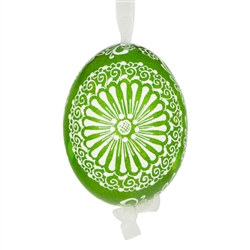 This beautifully designed egg is dyed one color, then white wax is melted and applied to form an intricate design which is left on the surfce. The egg is emptied and strung with ribbon for hanging.