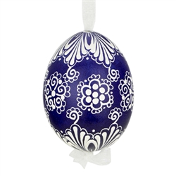 This beautifully designed egg is dyed one color, then white wax is melted and applied to form an intricate design which is left on the surfce. The egg is emptied and strung with ribbon for hanging.