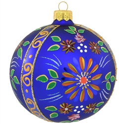 Delightfully patterned with colorful flowers and three vertical stripes of glistening gold, this 4" round sapphire blue ornament will lend its vivid enchantment to the tree! Exquisitely hand-painted with a myriad of vibrant glazes and dazzling glitter acc