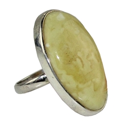 A beautiful custard color amber cabochon framed in a classic sterling silver frame. Size is approx 1.25" x .75".