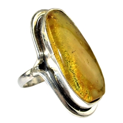 A beautiful honey color amber cabochon framed in a classic sterling silver frame. Size is approx 1.5" x .75".