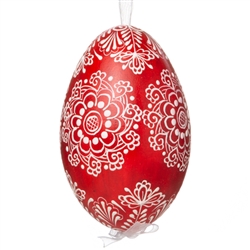 This beautifully designed egg is dyed one color, then white wax is melted and applied to form an intricate design which is left on the surfce. The egg is emptied and strung with ribbon for hanging. This is the work of master folk artist Anna Kicman.