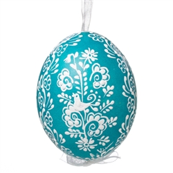 This beautifully designed egg is dyed one color, then white wax is melted and applied to form an intricate design which is left on the surfce. The egg is emptied and strung with ribbon for hanging.