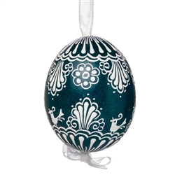 This beautifully designed egg is dyed one color, then white wax is melted and applied to form an intricate design which is left on the surfce. The egg is emptied and strung with ribbon for hanging.