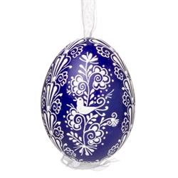 This beautifully designed egg is dyed one color, then white wax is melted and applied to form an intricate design which is left on the surfce. The egg is emptied and strung with ribbon for hanging.