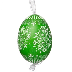 This beautifully designed egg is dyed one color, then white wax is melted and applied to form an intricate design which is left on the surfce. The egg is emptied and strung with ribbon for hanging.