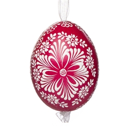 This beautifully designed egg is dyed one color, then white wax is melted and applied to form an intricate design which is left on the surfce. The egg is emptied and strung with ribbon for hanging.