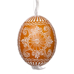 This beautifully designed egg is dyed one color, then white wax is melted and applied to form an intricate design which is left on the surfce. The egg is emptied and strung with ribbon for hanging.