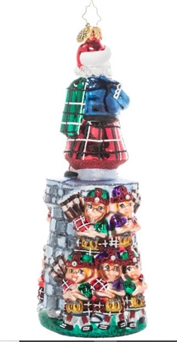 The penultimate addition to our Ornament of the Month series, this piece celebrates the 11th day of Christmas. You can practically hear the music coming from this team of tiny bagpipers led by their eleventh member and Christmas king himself, Santa Claus!