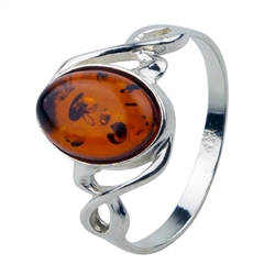 An oval of honey amber set in an artistic swirl of sterling silver.  Amber size is approx 0.5" x 0.3"