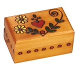 The lid of this box features a heart and flower design. Circular detailing around the sides completes the piece. Handmade in the Tatra Mountain region of Poland.