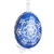 This beautifully designed egg is dyed one color, then white wax is melted and applied to form an intricate design which is left on the surfce. The egg is emptied and strung with ribbon for hanging.