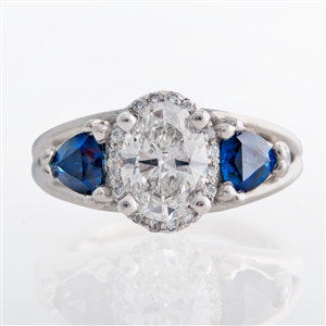 three stone oval halo diamond ring with trillion sapphires