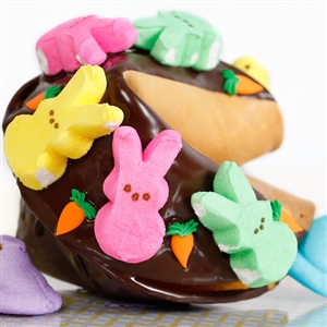 This Easter Gigantic fortune cookie is chocolate covered and decorated with marshmallow Peeps for springing into spring.