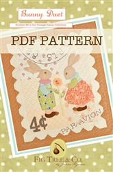 A vintage "stamp" wall hanging with an embroidered postmark and two adorable rabbits