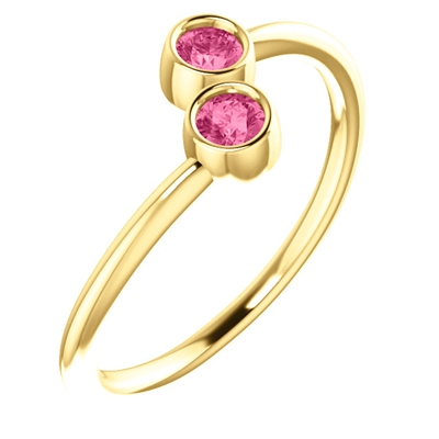 This cute 14k yellow gold pink tourmaline ring features two bezel set tourmalines with a warm pink hue.