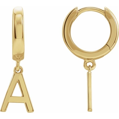 These sweet huggie hoop earrings feature a dangling gold initial attached to a huggie style hoop.