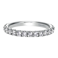 Glittering round diamonds sit pretty in 14k white gold in this diamond laden wedding band by Gabriel & Co.