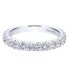 Diamonds wrap themselves three quarters around a 14k white gold band in this classic diamond wedding band.
