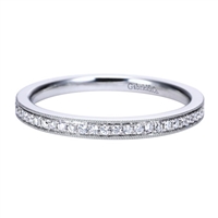 This 14k white gold diamond wedding band is simple but flashes elegantly with beaded white gold rows surrounding channel set round diamonds.